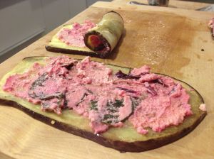 Eggplant slices spread with ricotta mixture and rolled. 