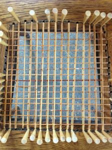 Weaving the first horizontal strip. 